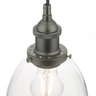 Close-up of the grey metal fitting and a clear bell-shaped glass shade with a visible bulb.