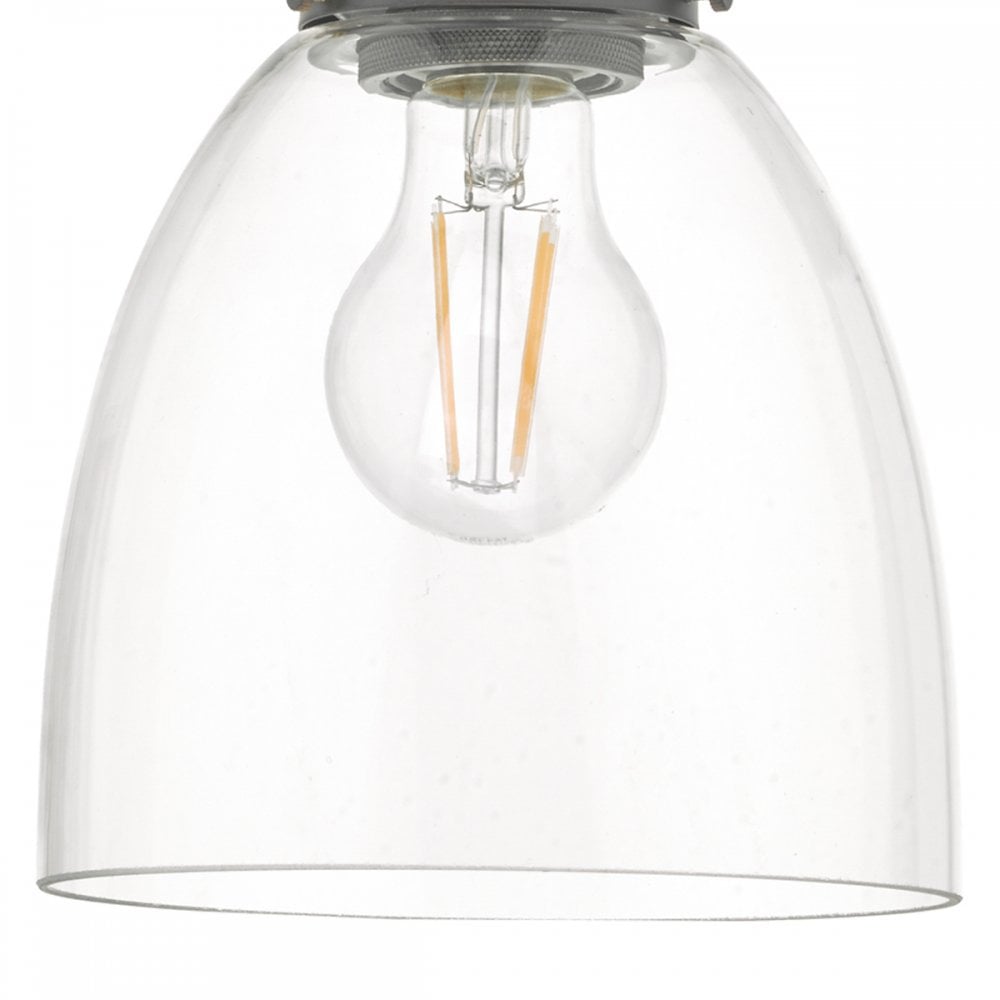 Close-up of the clear bell-shaped glass shade and the exposed filament bulb inside.