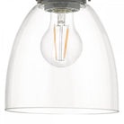 Close-up of the clear bell-shaped glass shade and the exposed filament bulb inside.