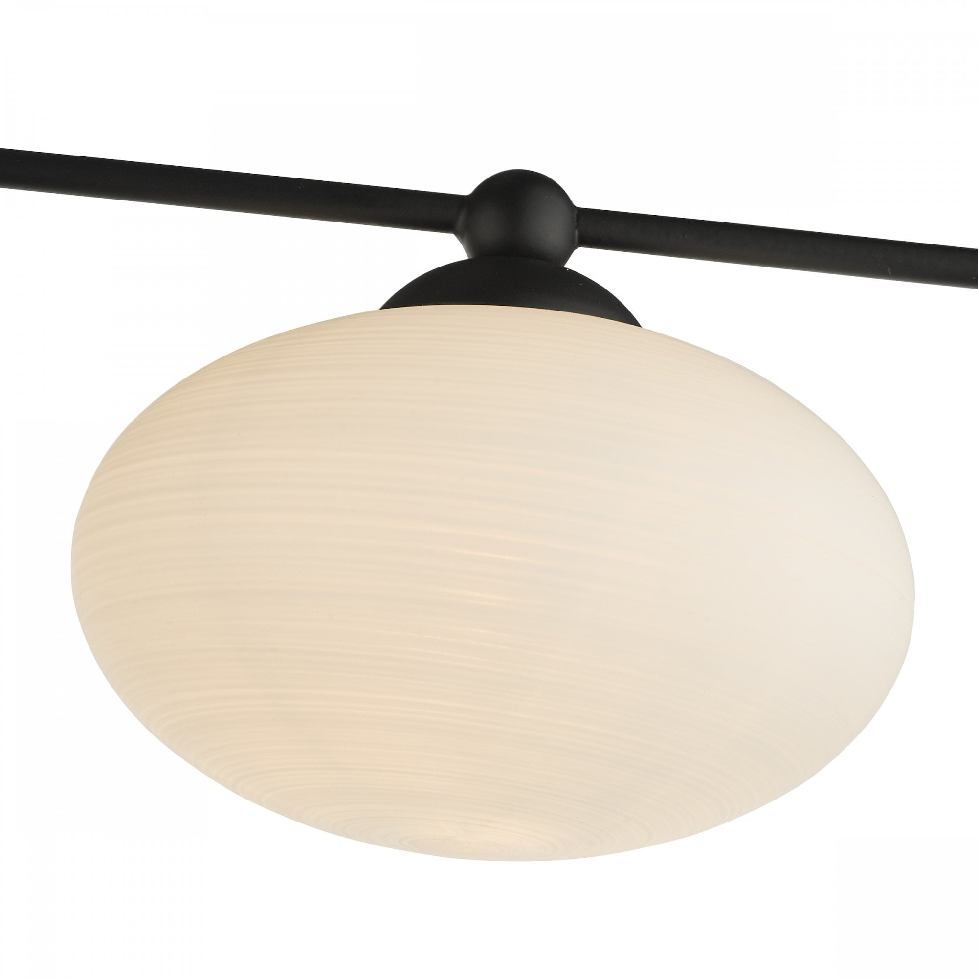 Close-up of a single white orb diffuser on a black modern ceiling light.