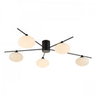 Black and white modern ceiling light with five orb-shaped diffusers.