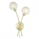 A modern double wall light with two clear glass orb shades and a brass base.