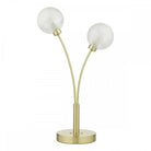 A modern two-bulb table lamp with spherical shades and a brushed brass finish.