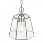 Close-up of polished nickel pendant light with clear glass shade and exposed bulb.