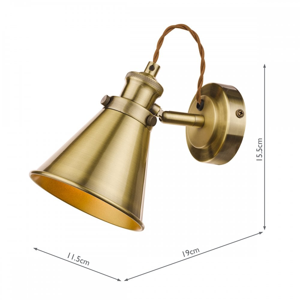An industrial brass cone wall light with dimensions of 11.5cm, 19cm, and 15.5cm.