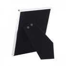 Rear view of a silver photo frame, showcasing the black velvet backing and stand.
