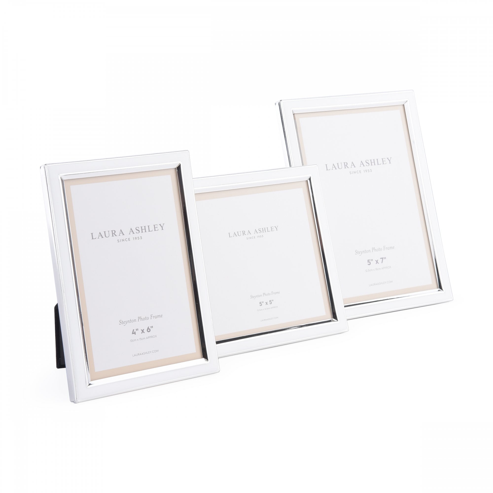 A trio of silver photo frames in varying sizes, artfully arranged together.