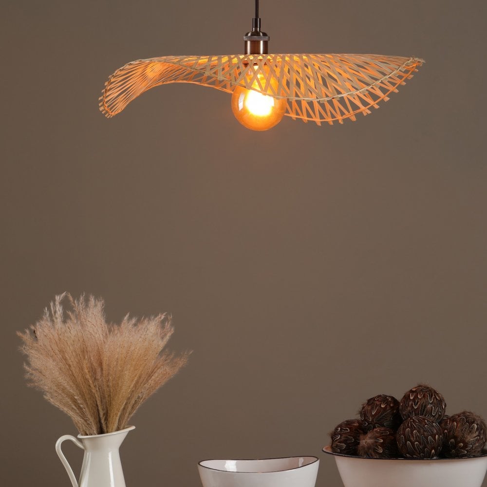 The ceiling light illuminates a dining setting with bowls and a white jug with pampas grass.
