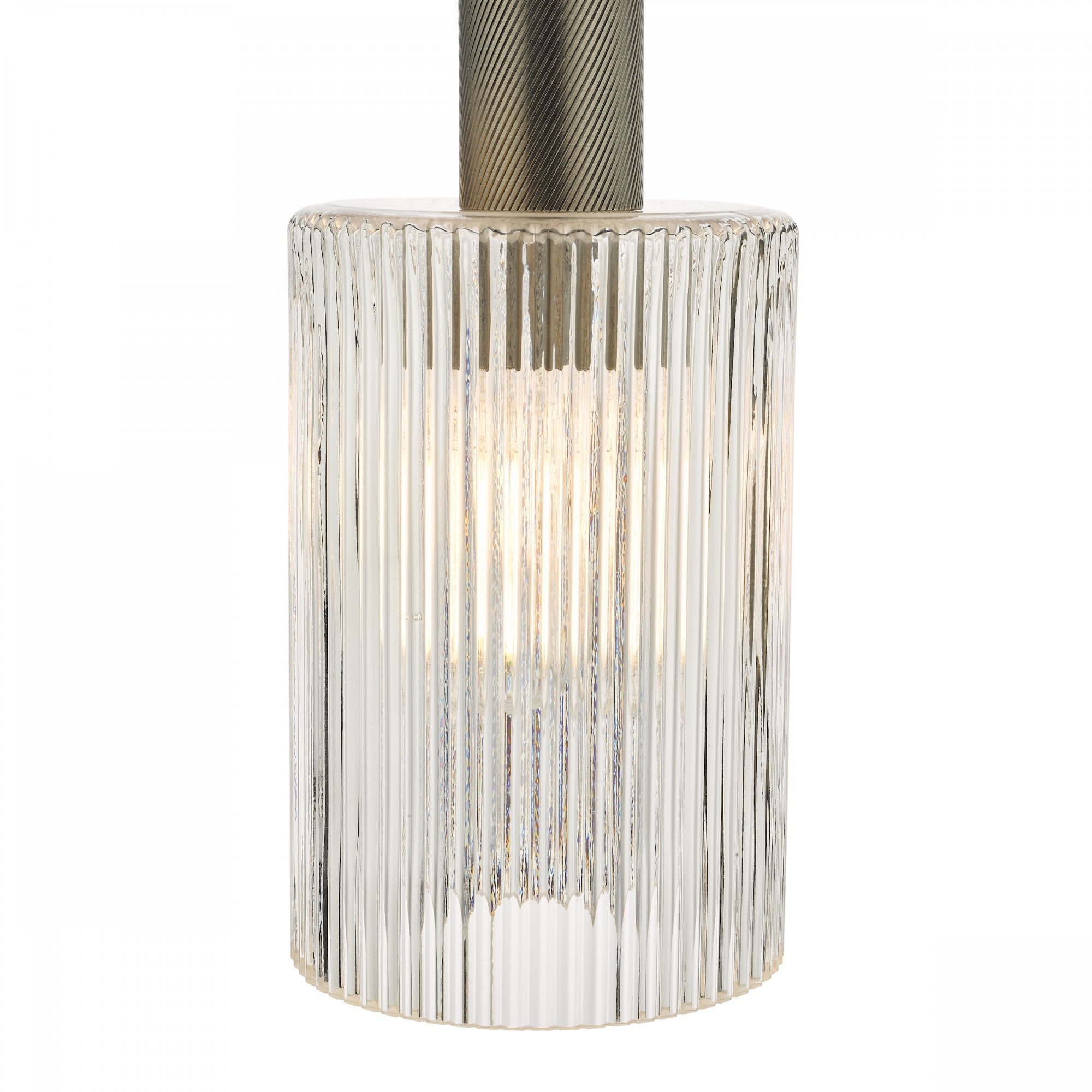Close-up of an illuminated ribbed glass pendant light with antique brass fitting.