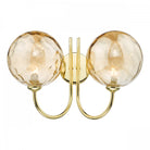 Brass wall light with two amber textured glass spheres.