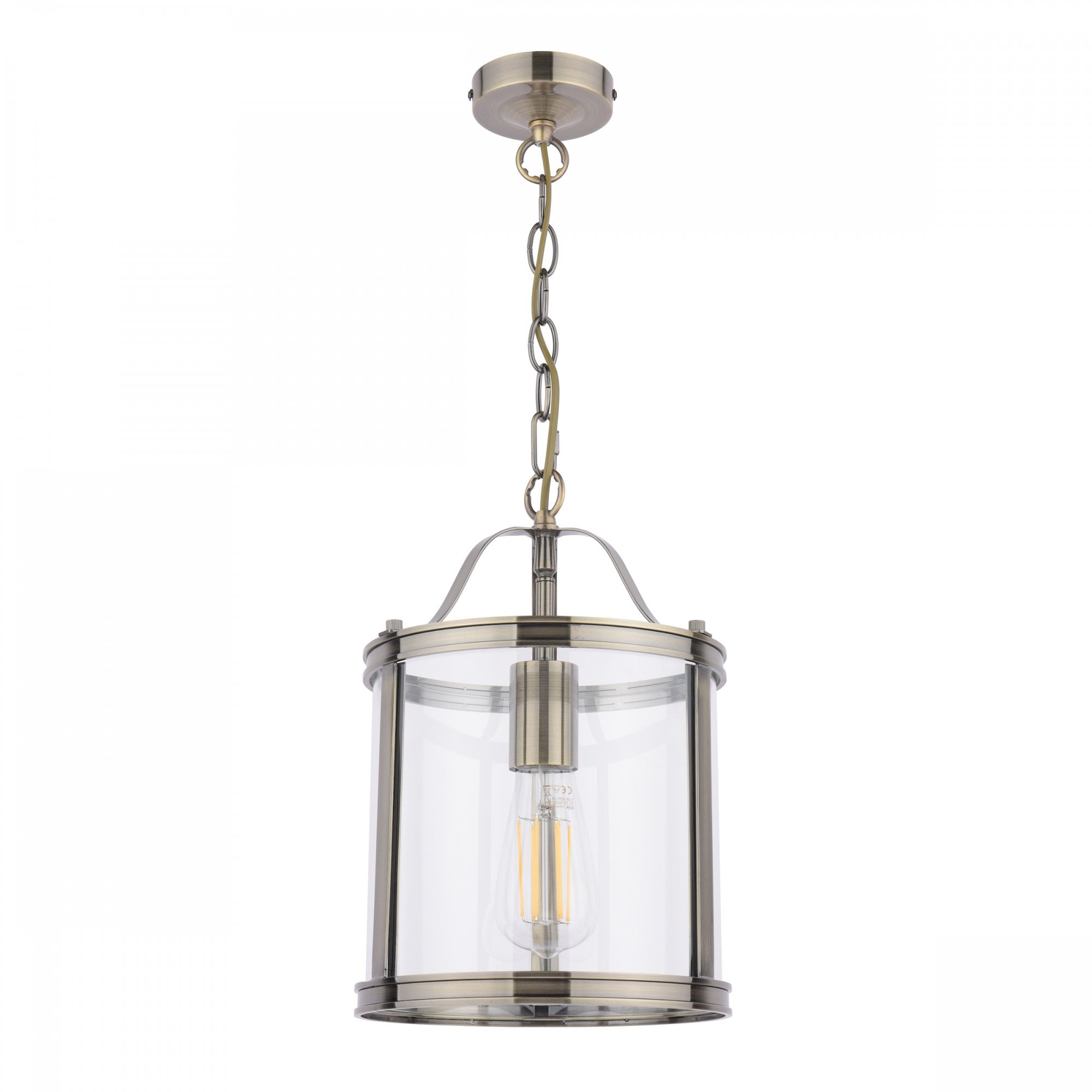 A vintage style pendant light with a clear glass shade and antique brass finish, isolated on white.