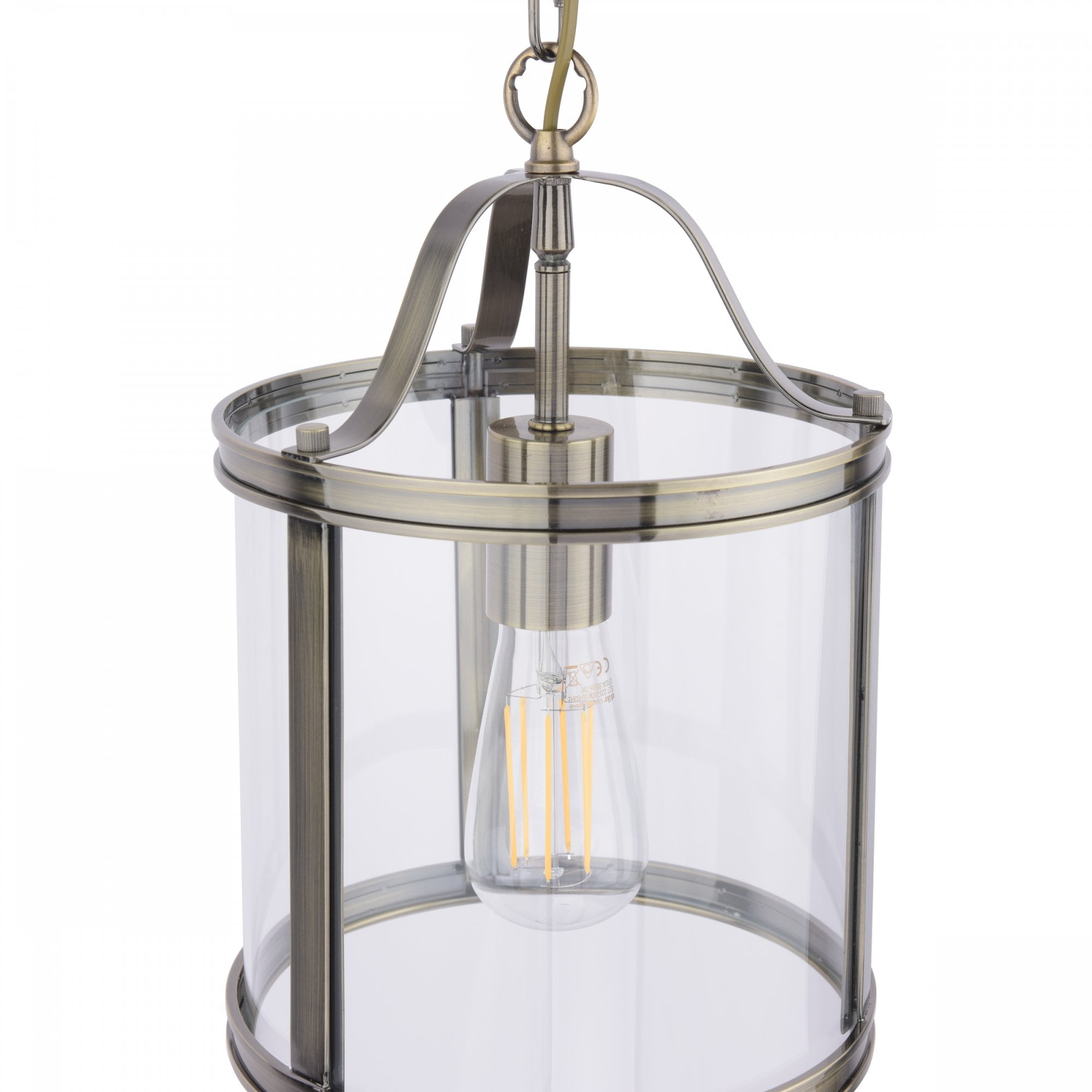 Close-up of a vintage style pendant light with a clear glass shade and antique brass finish.