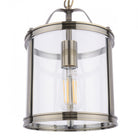 Front view of a vintage style pendant light with a clear glass shade and antique brass finish.