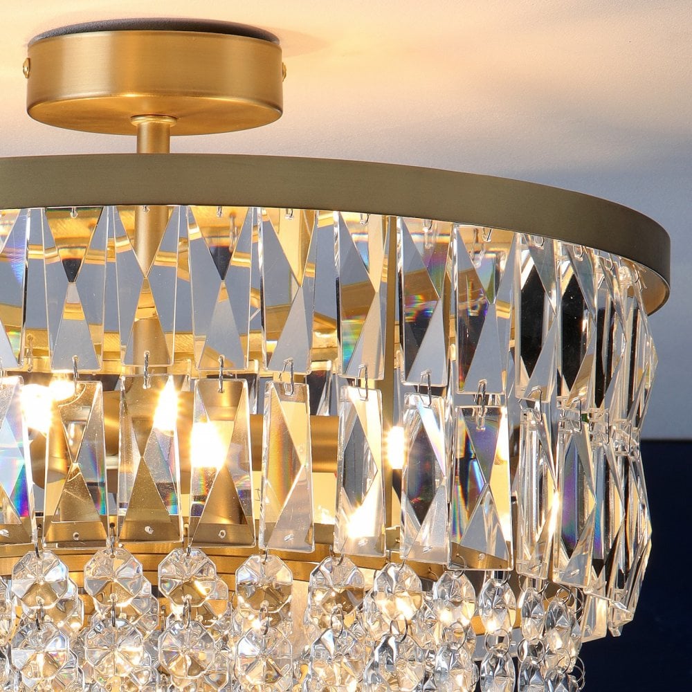 Close-up of a crystal chandelier showing details of the crystal and gold fixture.