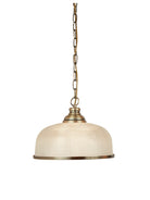 A pendant lamp with an off-white glass dome shade and brass-colored chain and trim.