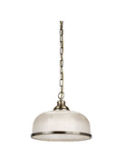 A pendant lamp with a silver chain and trim, and a clear, textured glass dome shade.