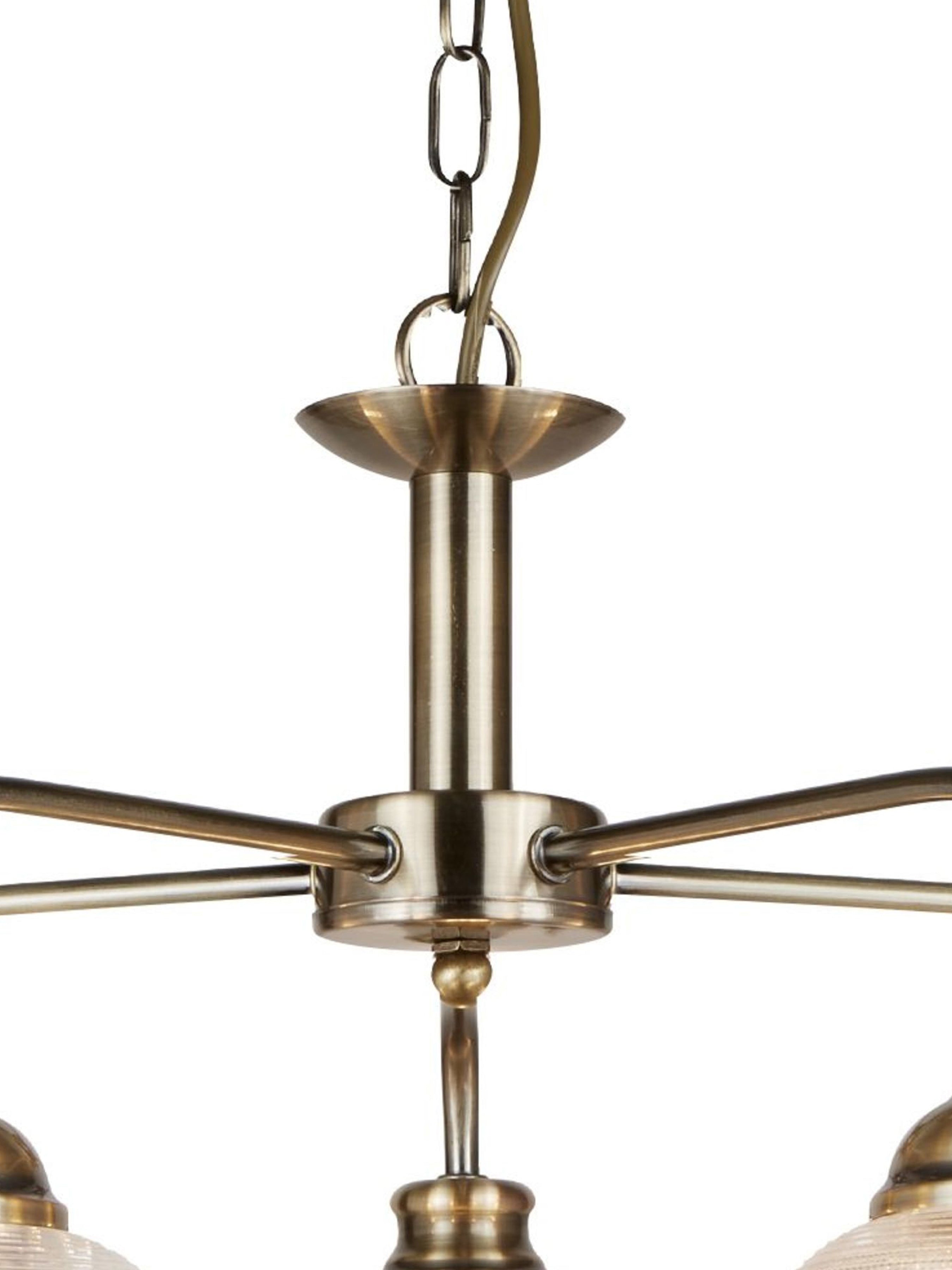 Close-up of the antique brass chain and stem of a chandelier.