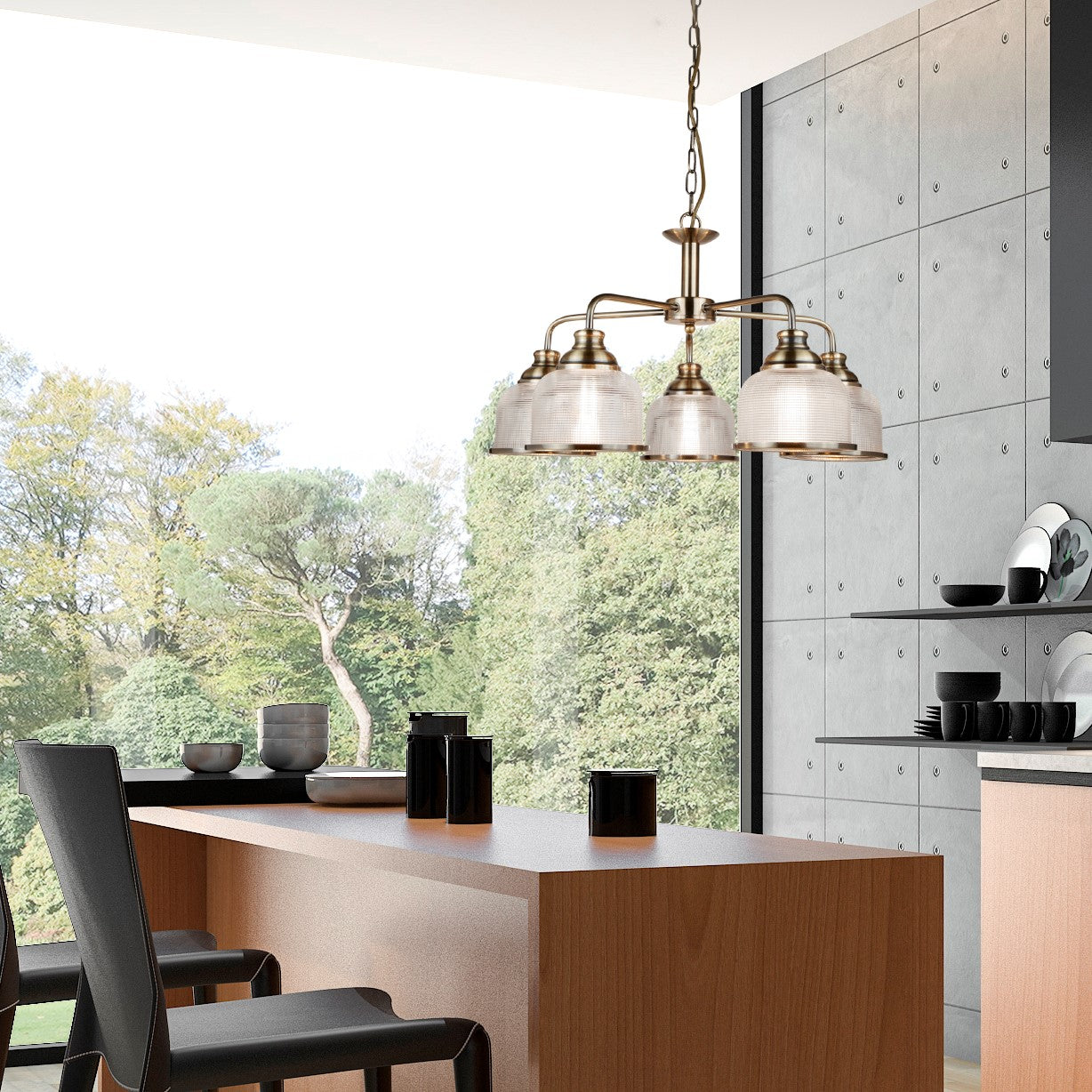 A five-arm chandelier illuminating a modern kitchen island with chairs.