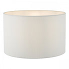 White cylindrical lampshade, illuminated from within.