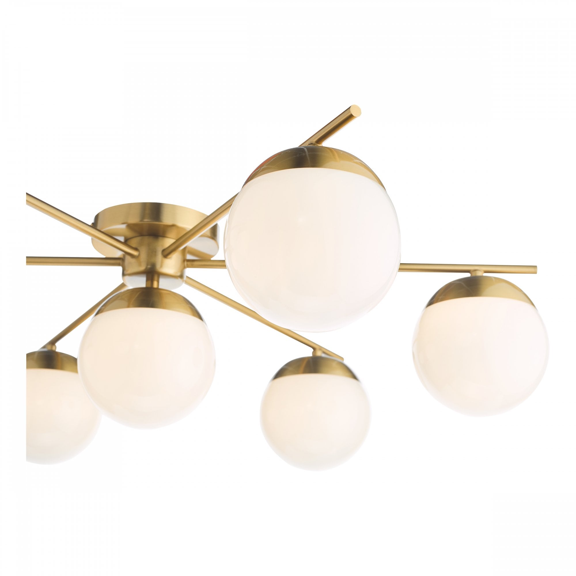 Close-up of a brass ceiling light fixture with seven white globe shades.
