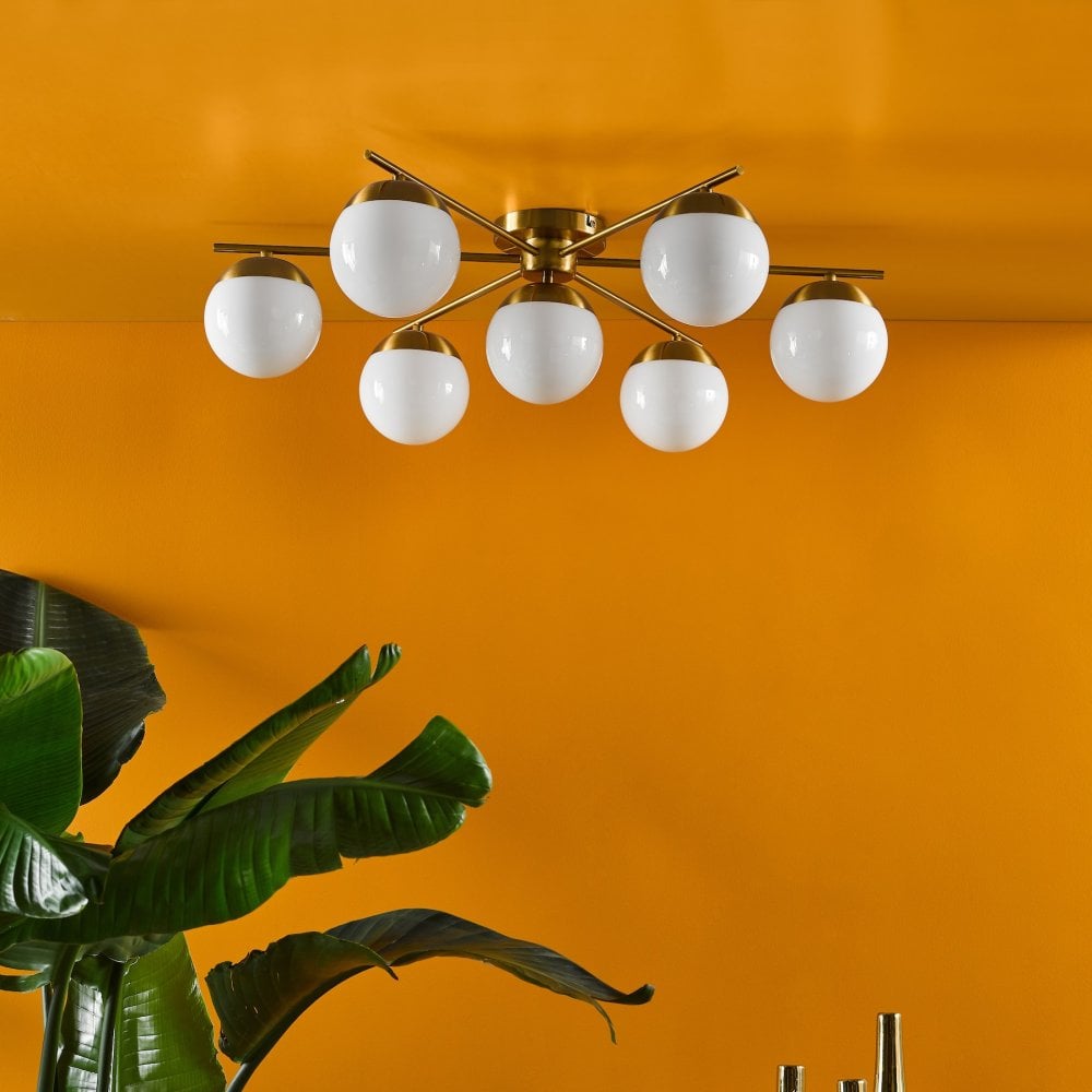 Seven-light ceiling fixture with white globe shades and a warm yellow background.