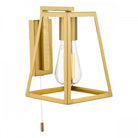 A modern gold wall light with a geometric frame and exposed bulb with a pull cord switch.