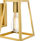 Close-up of a modern gold wall light with a geometric frame and exposed bulb.