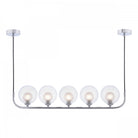 Five clear globe lights on a chrome bar, suspended from two ceiling mounts.