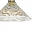 A close-up of the fluted glass shade of the semi-flush ceiling light.