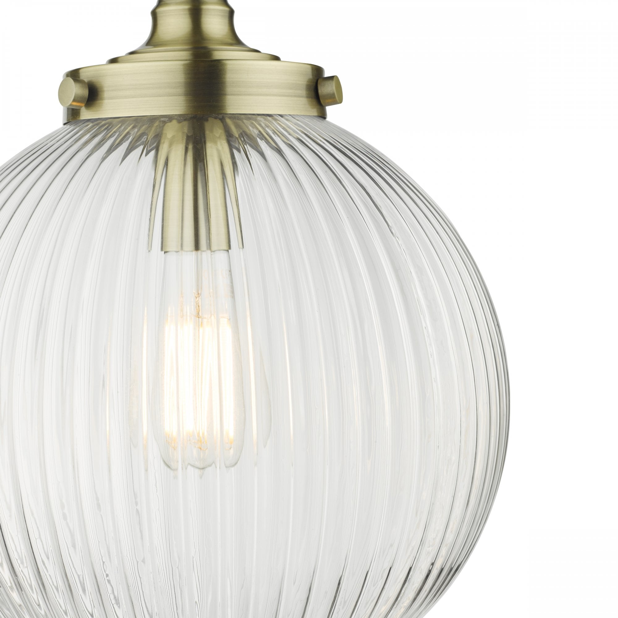 Close-up of a ribbed glass globe pendant light with brass accents, showing the texture and bulb.