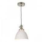 A modern pendant light with a white ribbed dome shade and a braided cord.