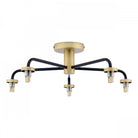 A modern semi-flush ceiling light with five black arms and brass accents.