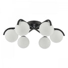 Contemporary black ceiling fixture featuring six spherical white diffusers.