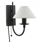 A black wall sconce with a white conical shade and a pull chain switch.