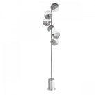 A modern chrome floor lamp with five spherical glass shades in an ascending spiral pattern.