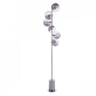 A modern chrome floor lamp with five spherical glass shades in an ascending spiral pattern.