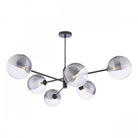 A modern black chandelier with six glass globe shades, half clear and half ribbed silver.