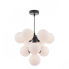 Modern black chandelier with ten white globe lights hanging from a black cord.