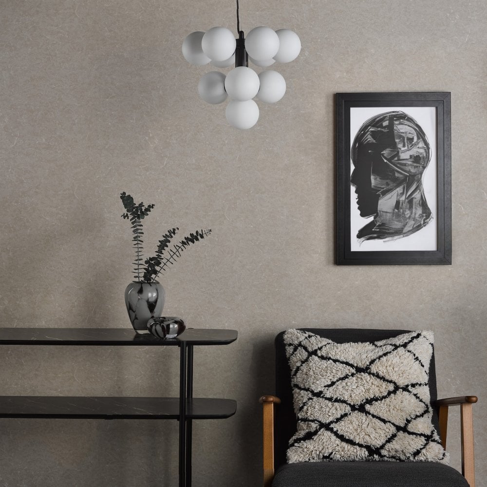 Modern chandelier with ten white globes in a stylish living room setting.