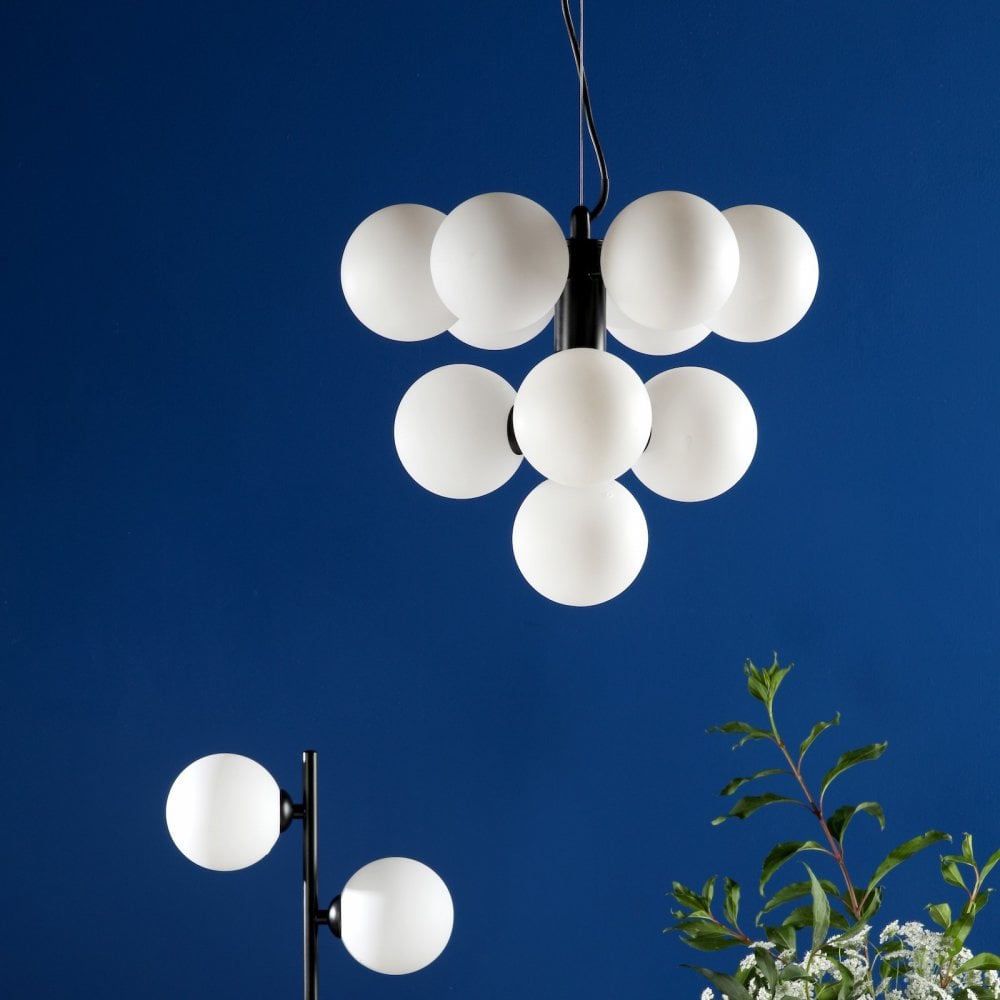 Modern black chandelier with ten white globe lights against a striking blue background.