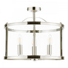 A detailed shot of a semi-flush chrome ceiling light with a clear glass shade and bulbs.