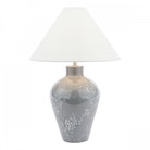 A white tapered lampshade on a grey base with white flowers on a white background.