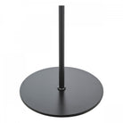 Close-up of the round, black base of the modern floor lamp, providing stability.