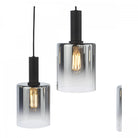Two cylindrical pendant lights with smoked glass shades and exposed Edison bulbs.
