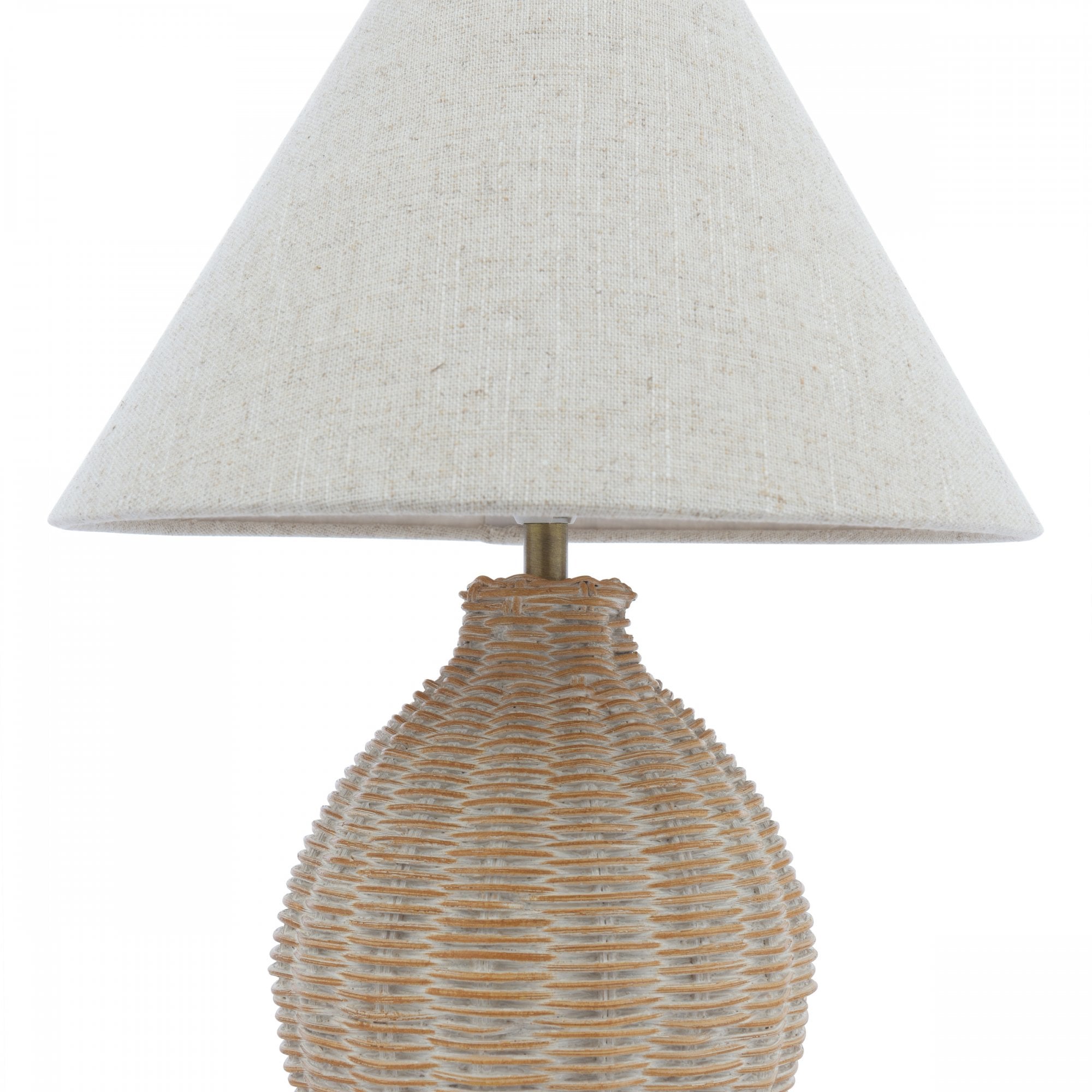 A close-up studio shot of a wicker table lamp with a conical off-white shade.