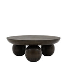 A large round coffee table made of dark wood with three spherical legs on a white background.