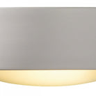 Close-up of a white rectangular wall light with a curved base, emitting a warm glow.