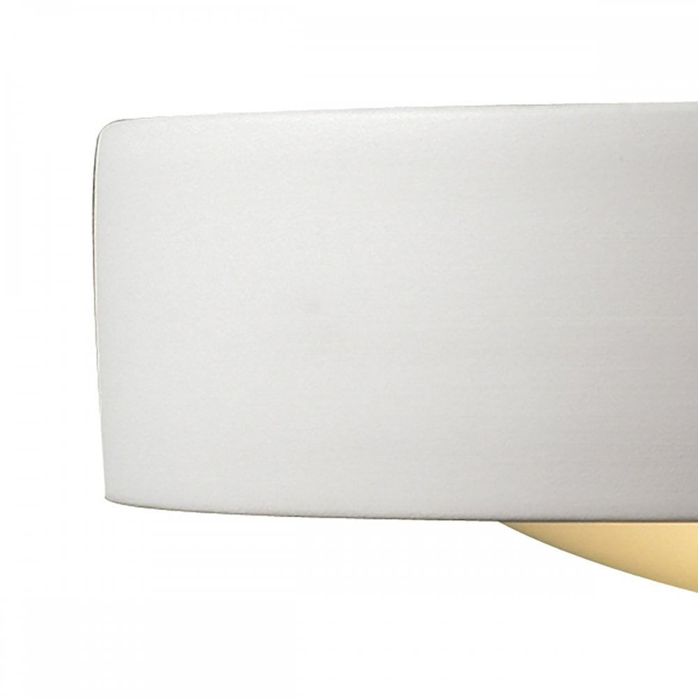 Side view of a white rectangular wall light with a curved base, emitting a warm glow.