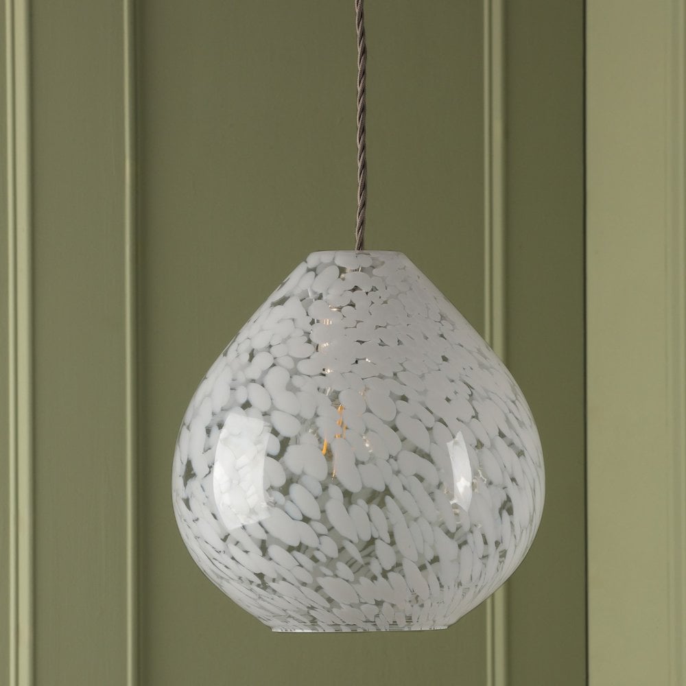 Teardrop pendant light with white and clear speckled glass against a green panelled wall.