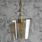 A close-up view of the pendant light with the bulb unlit.